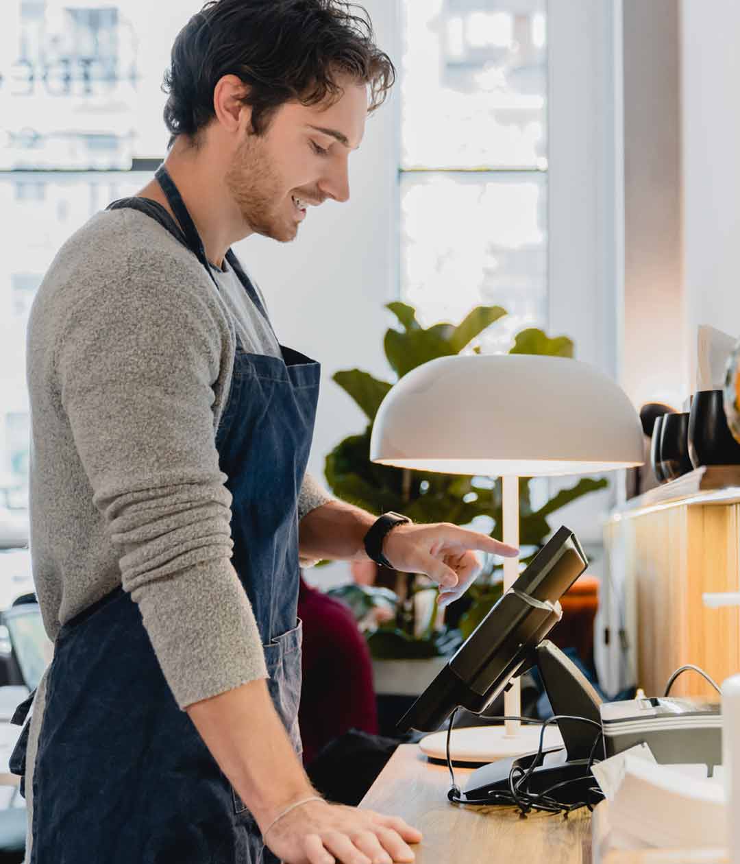 Merchant at work on electronic register